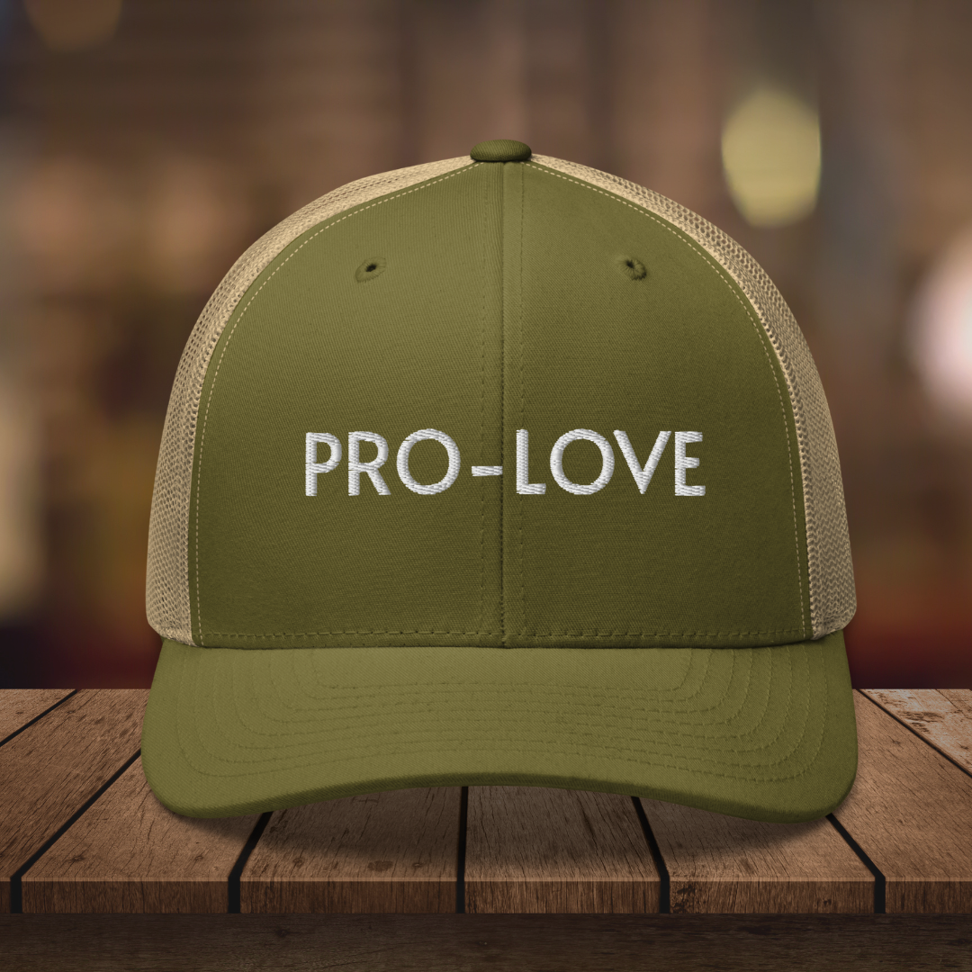 PRO-LOVE| TRUCKER HAT| FEEL THE FACTS A front view of the Pro-Love Trucker Hat, featuring the embroidered "Pro-Love" logo on the front and a stylish mesh design on the sides. MOSS_KHAKI