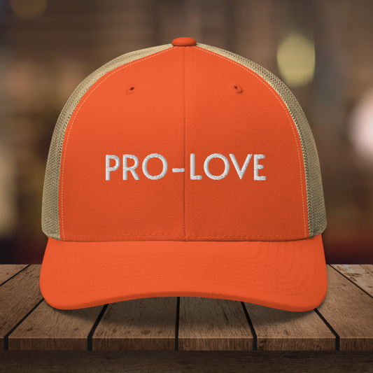 PRO-LOVE| TRUCKER HAT| FEEL THE FACTS A front view of the Pro-Love Trucker Hat, featuring the embroidered "Pro-Love" logo on the front and a stylish mesh design on the sides. ORANGE