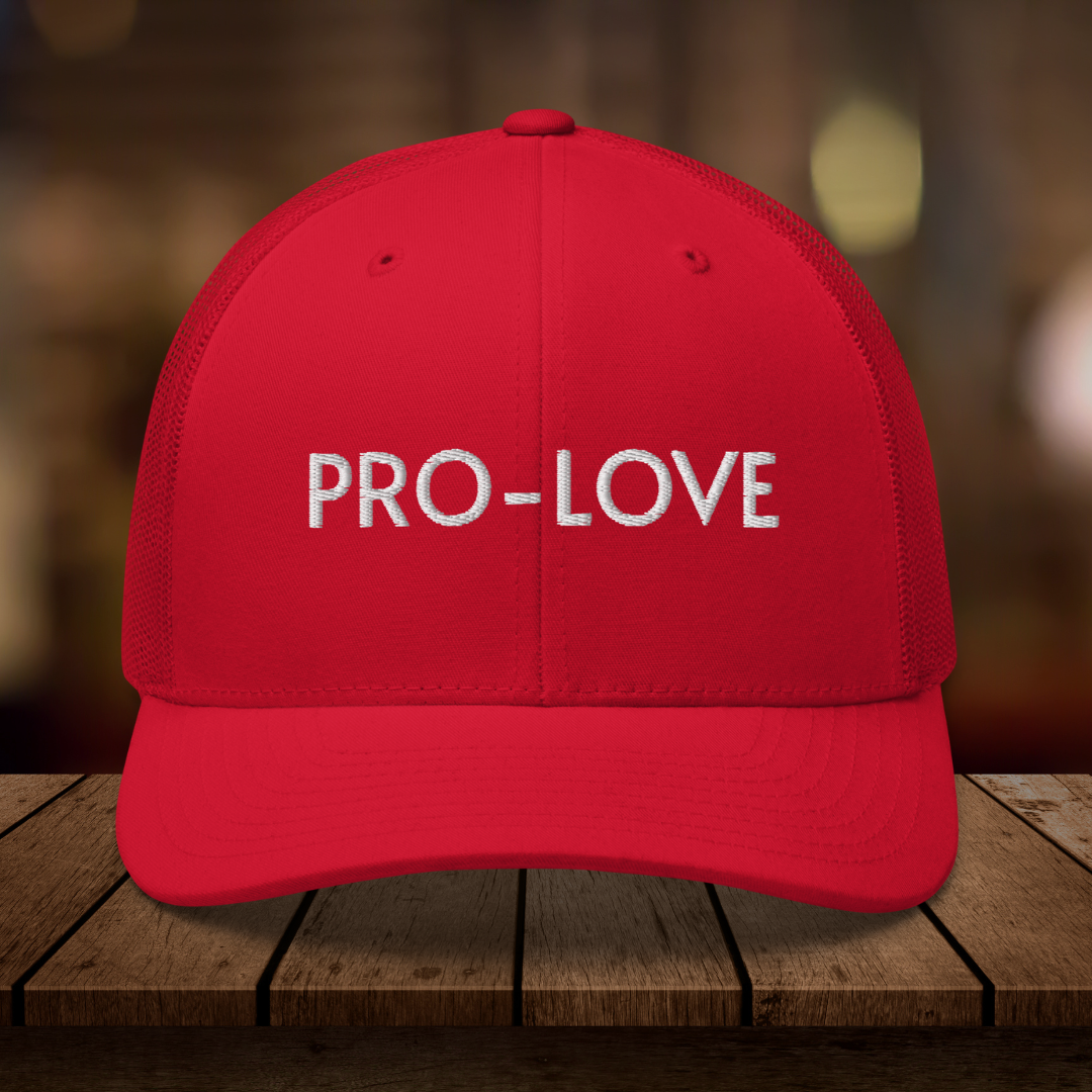 PRO-LOVE| TRUCKER HAT| FEEL THE FACTS A front view of the Pro-Love Trucker Hat, featuring the embroidered "Pro-Love" logo on the front and a stylish mesh design on the sides. RED